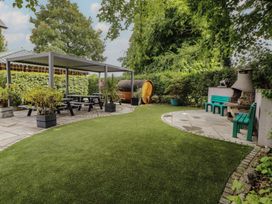 A garden with a gazebo and outdoor furniture at Eden Lodge in Bardsea