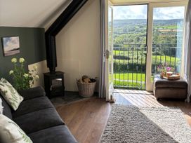 A living room with a view of the countryside at Ysgubor - The Barn Boncath near Crymych