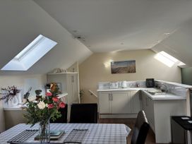 A kitchen with table and chairs at Ysgubor - The Barn in Boncath near Crymych