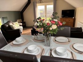 A dining table with bowls set for a meal at Ysgubor - The Barn in Boncath near Crymych