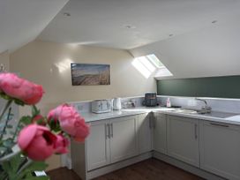 A kitchen with a sink, kettle, and toaster at Ysgubor - The Barn in Boncath near Crymych