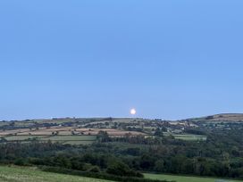 A landscape with fields, hills, trees and the moon at Ysgubor - The Barn Boncath near Crymych