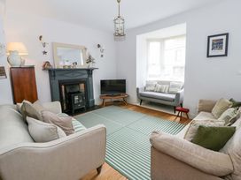 A living room with sofas and a television at Rose Cottage St Dogmaels near Cardigan