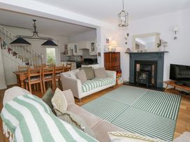 A living room with a sofa and dining table at Rose Cottage in St Dogmaels near Cardigan