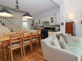 A kitchen with dining table and chairs at Rose Cottage in St Dogmaels near Cardigan