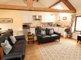 A living room with a kitchen area at Stable Cottage in Bolton Low Houses