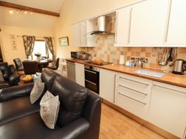 A kitchen with a dining area and seating at Stable Cottage Bolton Low Houses