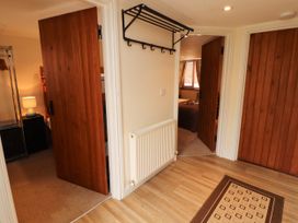 A hallway with doors and a coatrack at Stable Cottage in Bolton Low Houses