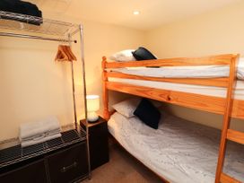 A bedroom with a bunk bed and shelving at Stable Cottage in Bolton Low Houses