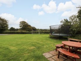 A garden with a trampoline and soccer goal at Stable Cottage in Bolton Low Houses