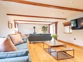 A living room with sofas and a coffee table at Ty Gwyn in Llangwm near Bala
