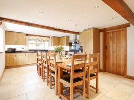 A dining room with a table and chairs at Ty Gwyn in Llangwm near Bala