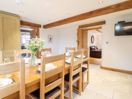 A dining room with a table set for dinner at Ty Gwyn in Llangwm near Bala