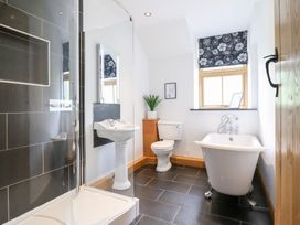 A bathroom with a shower, sink, toilet and bathtub at Ty Gwyn in Llangwm near Bala
