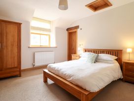 A bedroom with a bed and bedside tables at Ty Gwyn in Llangwm near Bala