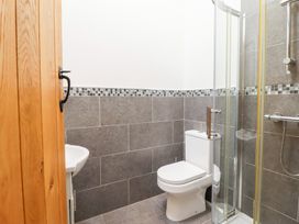 A bathroom with a shower, toilet, and sink at Ty Gwyn in Llangwm near Bala