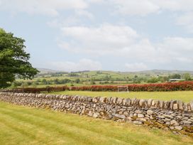 An outdoor photo of a landscape with a stone wall and a goal post at Ty Gwyn in Llangwm near Bala