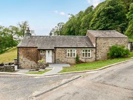 A cottage with a pathway and garden at Dove Cottage at the Graythwaite Estate Graythwaite Estate near Hawkshead