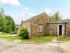 An outdoor area with a stone building and pathway at Dove Cottage at the Graythwaite Estate near Hawkshead