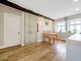 A kitchen with a table and chairs at Dove Cottage at the Graythwaite Estate near Hawkshead