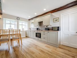 A kitchen with a table and chairs at Dove Cottage at the Graythwaite Estate near Hawkshead