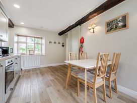 A kitchen with a dining table and chairs at Dove Cottage at the Graythwaite Estate near Hawkshead