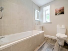 A bathroom with a bathtub and toilet at Dove Cottage at the Graythwaite Estate near Hawkshead