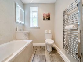 A bathroom with a bathtub and toilet at Dove Cottage at the Graythwaite Estate near Hawkshead