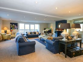 A living room with sofas and a coffee table at Nant-yr-Rhedyn in Red Wharf Bay