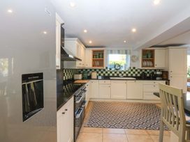 A kitchen with appliances and countertop features at Nant-yr-Rhedyn Red Wharf Bay