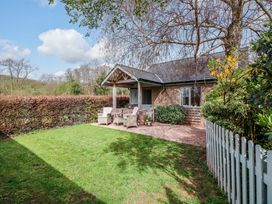 An outdoor area with seating and greenery at The Lodge, Lower Trefedw in Pandy near Abergavenny