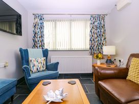 A living room with armchairs and a coffee table at The Lodge, Lower Trefedw, Pandy near Abergavenny