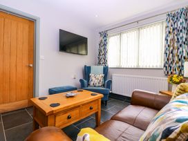 A living room with a sofa and coffee table at The Lodge, Lower Trefedw, Pandy near Abergavenny