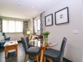 A living room with a table and chairs at The Lodge, Lower Trefedw Pandy near Abergavenny