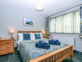 A bedroom with a bed and bedside lamps at The Lodge, Lower Trefedw, Pandy near Abergavenny