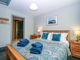 A bedroom with a bed and towels on the bed at The Lodge, Lower Trefedw Pandy near Abergavenny