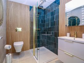 A bathroom with a shower, toilet, and sink at The Lodge, Lower Trefedw Pandy near Abergavenny