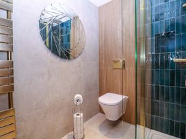 A bathroom with a shower and toilet at The Lodge, Lower Trefedw Pandy near Abergavenny