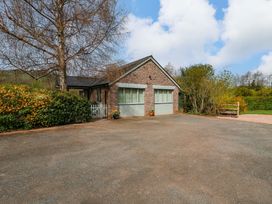 A house with a driveway and garden at The Lodge, Lower Trefedw in Pandy near Abergavenny