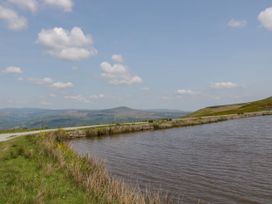 A scenic view with water and hills at The Lodge, Lower Trefedw, Pandy near Abergavenny