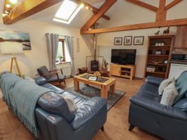 A living room with sofas and a coffee table at Hayloft Cottage Bolton Low Houses