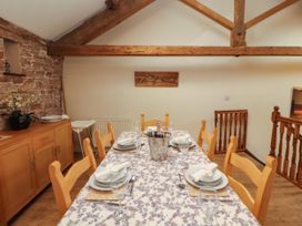 A dining room with a table set for meals at Hayloft Cottage Bolton Low Houses