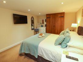 A bedroom with a bed and television at Hayloft Cottage Bolton Low Houses