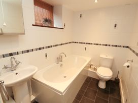 A bathroom with a bathtub, sink, and toilet at Hayloft Cottage in Bolton Low Houses