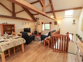 A living room with dining area at Horseshoe Cottage in Bolton Low Houses