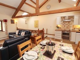 A living room with a dining area and kitchen units at Horseshoe Cottage in Bolton Low Houses