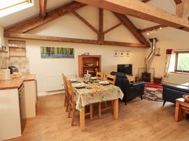A dining area with table and chairs at Horseshoe Cottage in Bolton Low Houses
