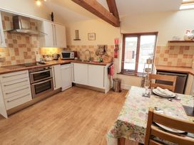 A kitchen with cabinets and appliances at Horseshoe Cottage in Bolton Low Houses