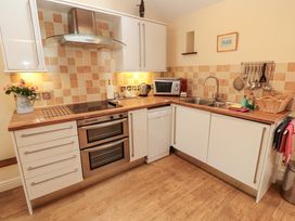 A kitchen with appliances and wooden countertops at Horseshoe Cottage in Bolton Low Houses