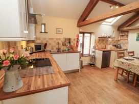 A kitchen with a stove and sink at Horseshoe Cottage in Bolton Low Houses
